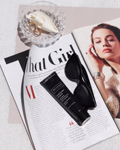 Load image into Gallery viewer, Revision Skincare Original Intellishade SPF 45 Tinted Moisturizer next to sunglasses and laying on a style magazine. Exclsuive Beauty Club is proud to be an authorized retailer of Revision Skincare.